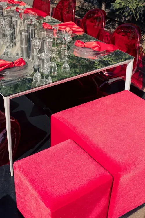 Прозрачно-дымчатый сет с красными акцентами за белым зеркальным прямоугольным столом