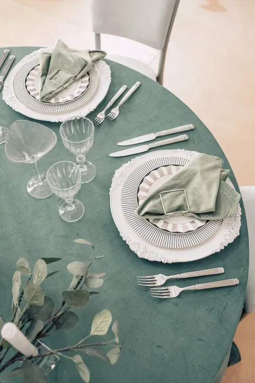 Сервировка в зеленых тонах за круглым столом